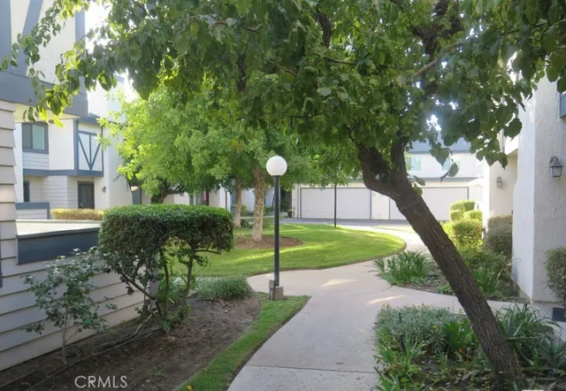 a view of a house with a yard and tree s