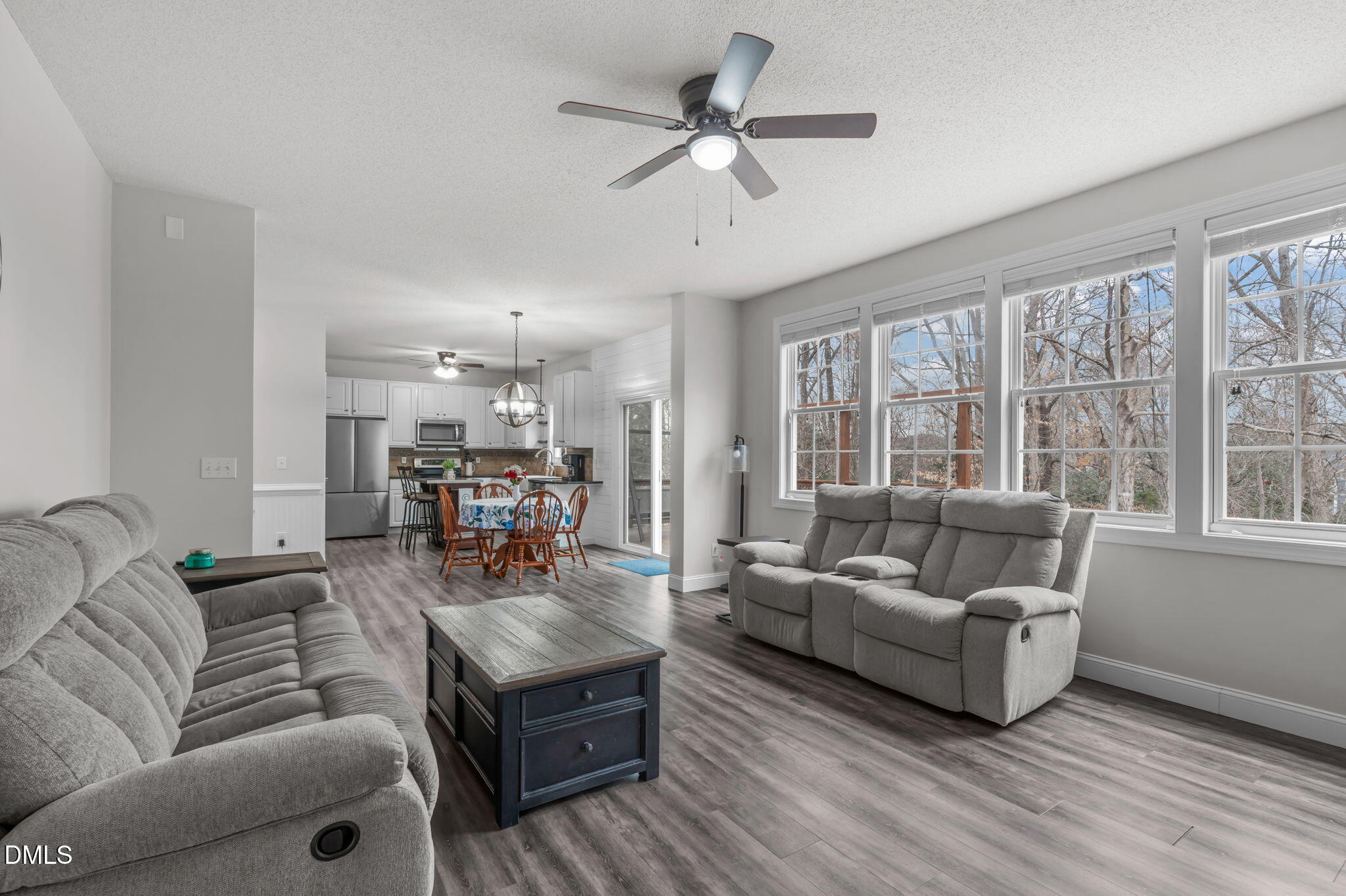 2501 Springfield Park Drive Raleigh, NC 27614 - Photo 18 of 44 a living room with furniture and a large window with wooden floor