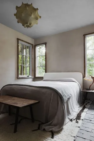 a spacious bedroom with a bed and a window