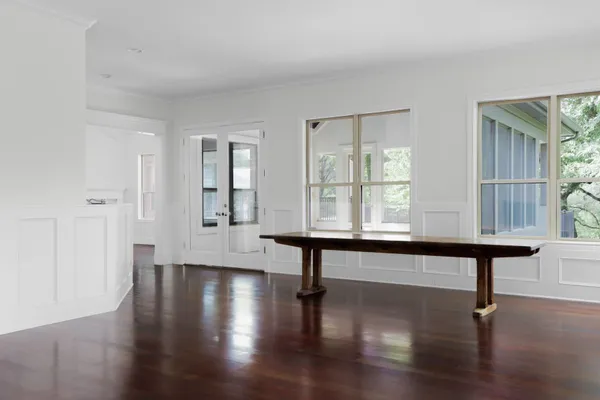 a room with wooden floor and windows