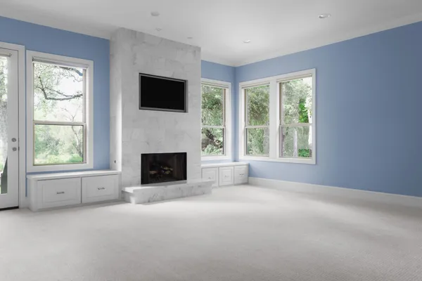 a view of a livingroom with an empty space and a fireplace