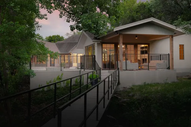 a view of a house with large windows and a yard