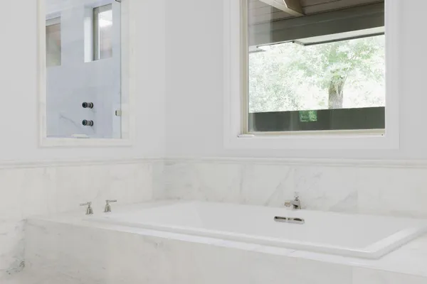 a white bath tub sitting next to a window