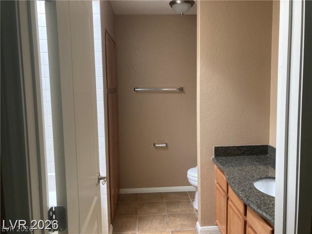3145 East Flamingo Road, Unit 2100 Las Vegas, NV 89121 - Photo 21 of 34 Functional bathroom featuring a shower, vanity with granite, and a tile floor.