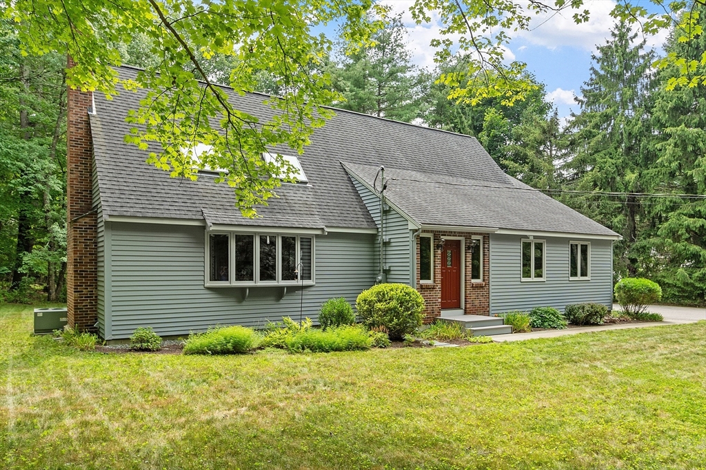 624 Old Harvard Road Boxborough, MA 01719 - Photo 1 of 42 a front view of a house with a garden