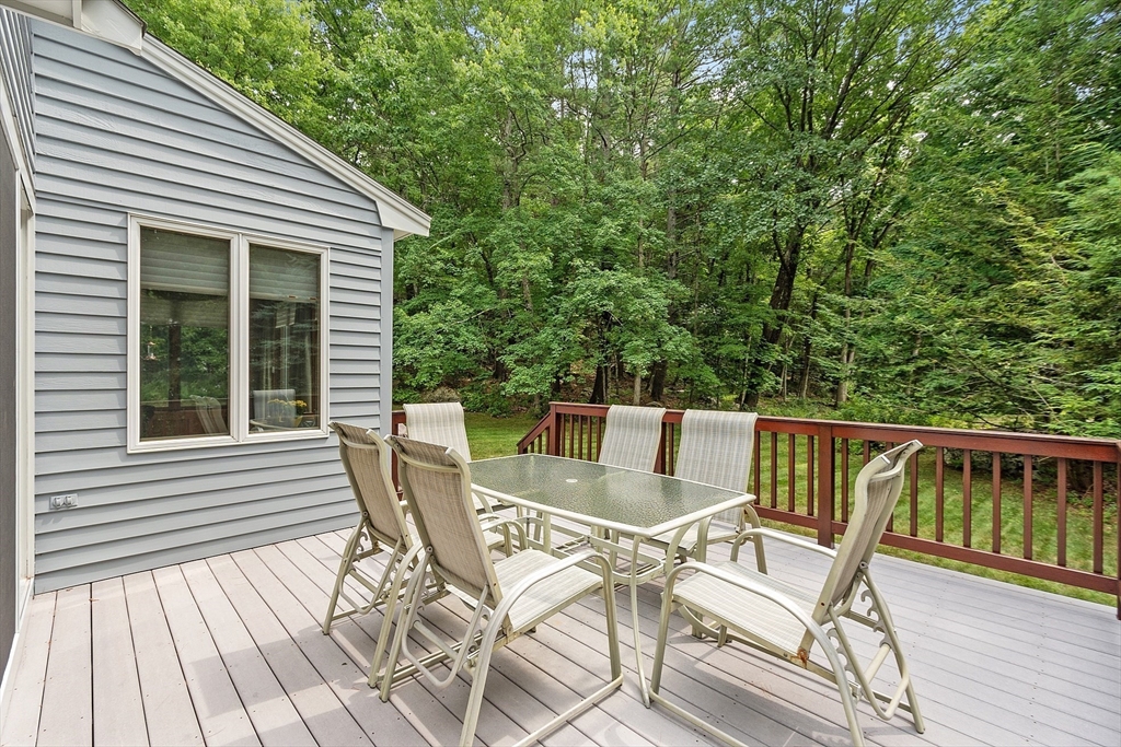 624 Old Harvard Road Boxborough, MA 01719 - Photo 14 of 42 a view of a chair and table on the deck
