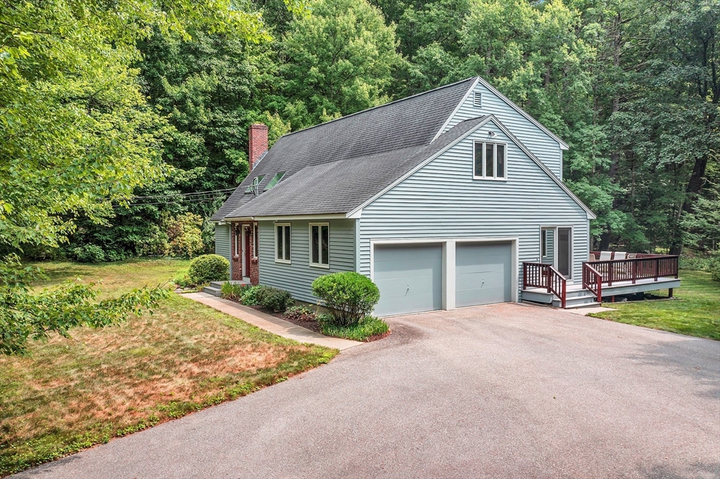 624 Old Harvard Road Boxborough, MA 01719 - Photo 2 of 42 a front view of a house with a garden and trees