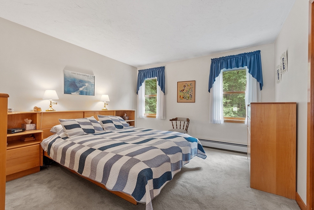 624 Old Harvard Road Boxborough, MA 01719 - Photo 21 of 42 a bed sitting in a bedroom next to a window