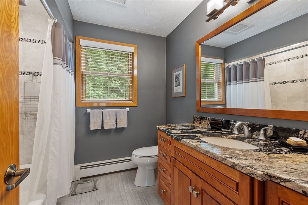 624 Old Harvard Road Boxborough, MA 01719 - Photo 23 of 42 a bathroom with a granite countertop sink toilet and mirror