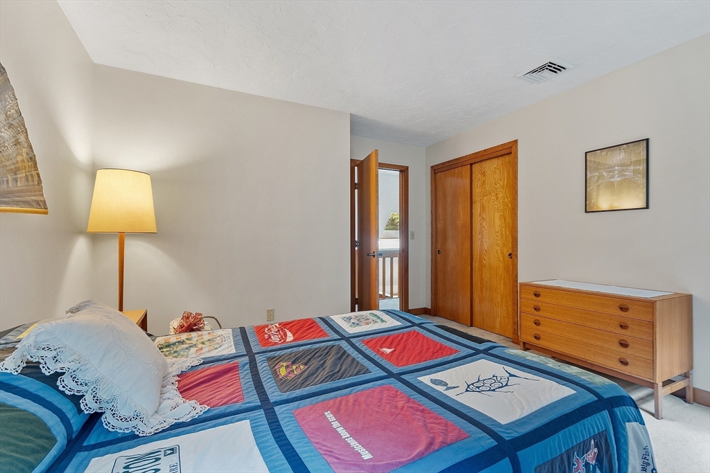 624 Old Harvard Road Boxborough, MA 01719 - Photo 26 of 42 a living room with a bed and a lamp