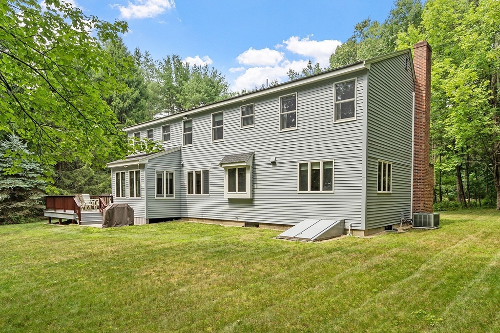 624 Old Harvard Road Boxborough, MA 01719 - Photo 3 of 42 a front view of house with yard and trees in the background