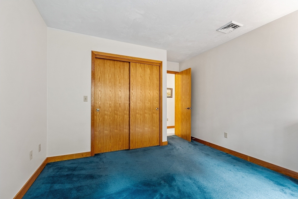 624 Old Harvard Road Boxborough, MA 01719 - Photo 31 of 42 a view of an empty room with wooden floor and closet