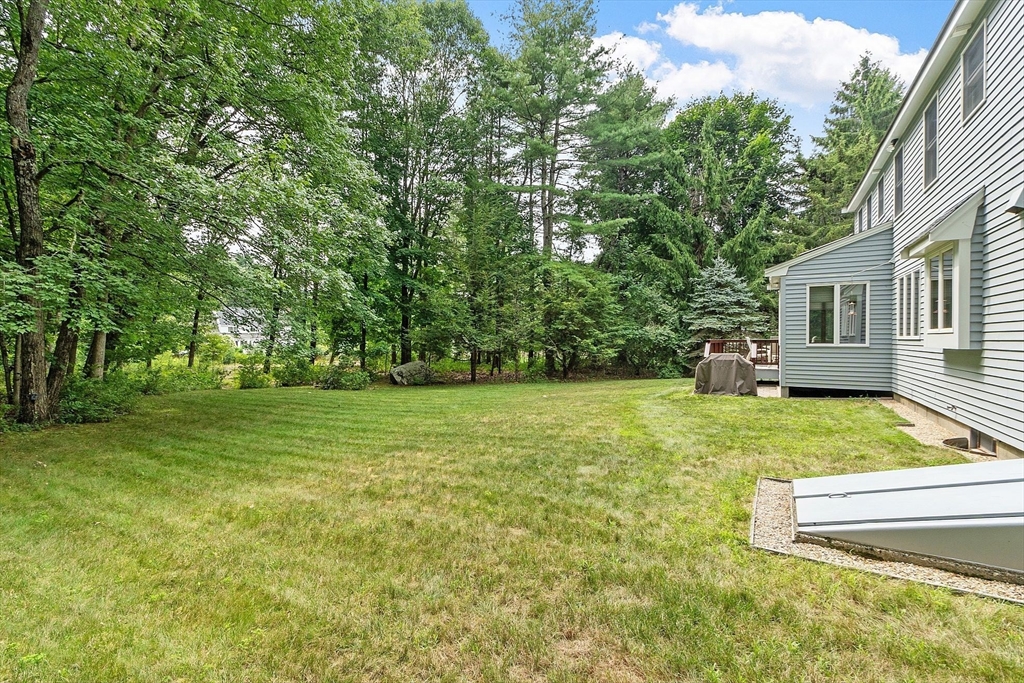 624 Old Harvard Road Boxborough, MA 01719 - Photo 35 of 42 a view of a house with a backyard and a tree