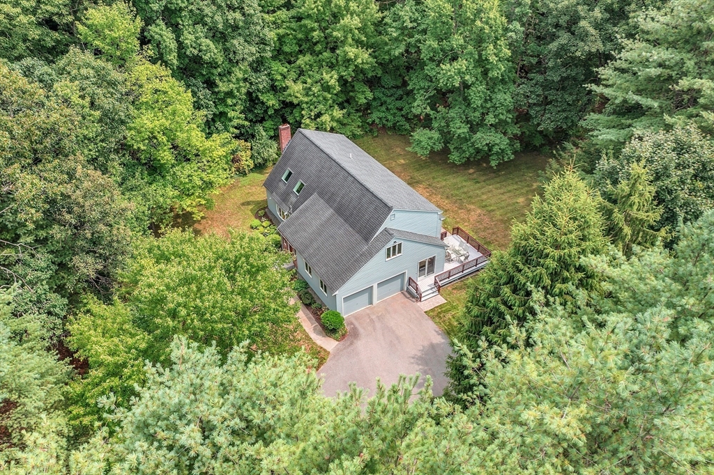 624 Old Harvard Road Boxborough, MA 01719 - Photo 38 of 42 an aerial view of a house with a yard and trees all around