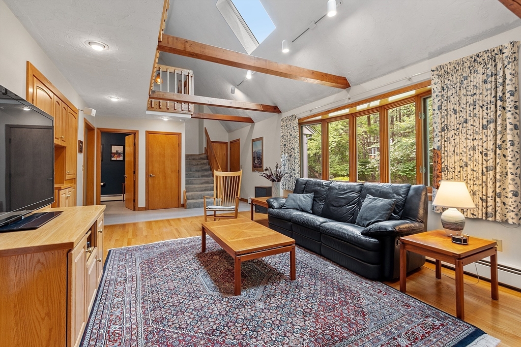 624 Old Harvard Road Boxborough, MA 01719 - Photo 7 of 42 a living room with patio furniture and a flat screen tv