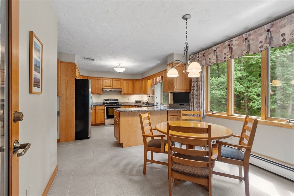624 Old Harvard Road Boxborough, MA 01719 - Photo 8 of 42 a view of a dining room with furniture window and outside view