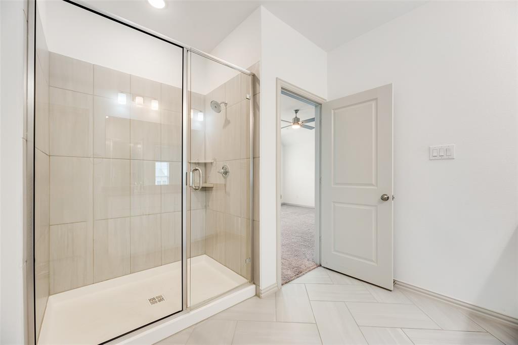9005 Phoebe Road Frisco, TX 75035 - Photo 20 of 23 a bathroom with a glass shower door