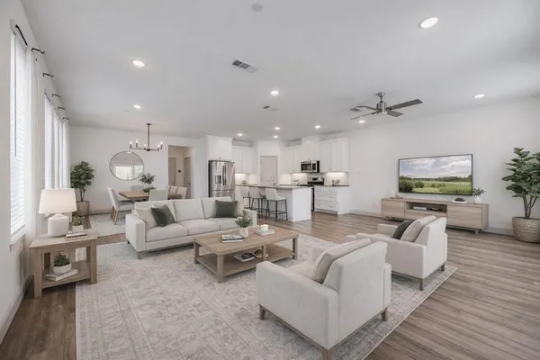 a living room with furniture and a wooden floor