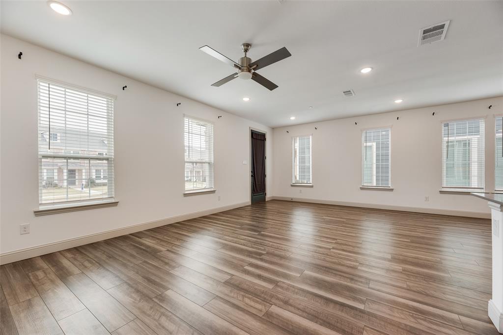 9005 Phoebe Road Frisco, TX 75035 - Photo 6 of 23 a view of an empty room with wooden floor and a window