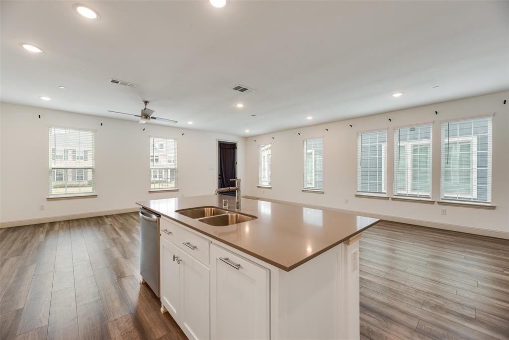 9005 Phoebe Road Frisco, TX 75035 - Photo 23 of 23 a kitchen with stainless steel appliances granite countertop a sink a oven and wooden floors