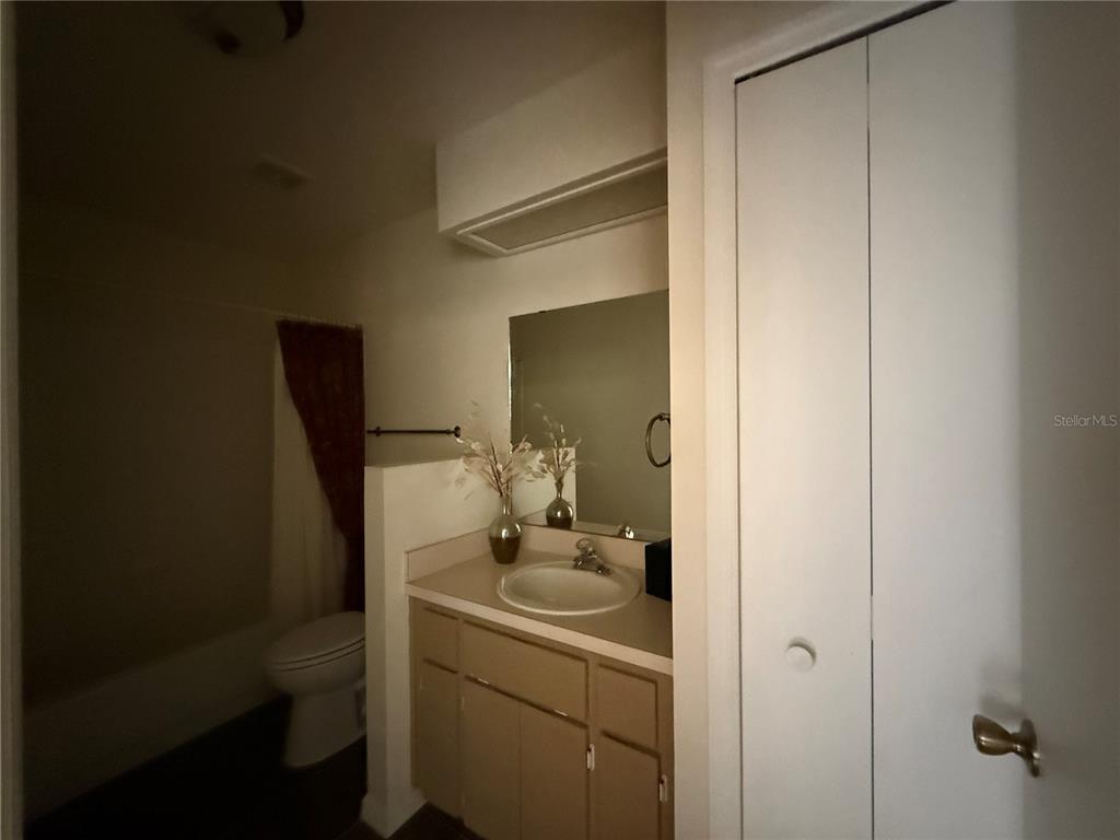 5510 Shriver Street Leesburg, FL 34748 - Photo 12 of 16 a bathroom with a sink and mirror with toilet