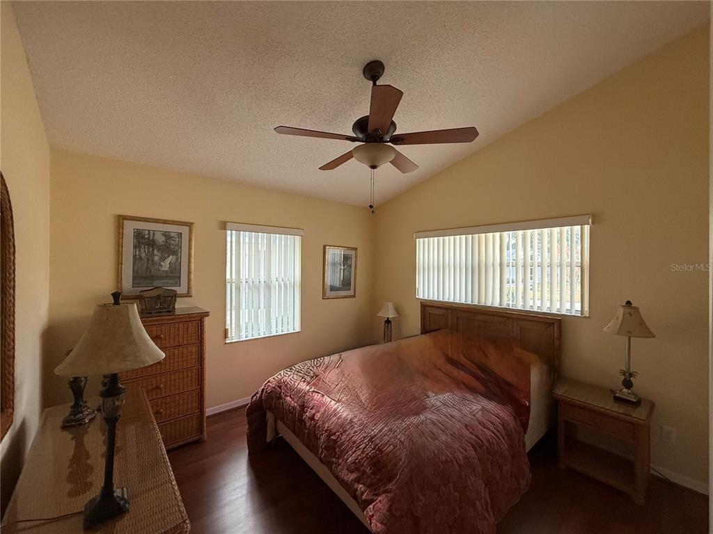 5510 Shriver Street Leesburg, FL 34748 - Photo 13 of 16 a bedroom with a bed and wooden floor