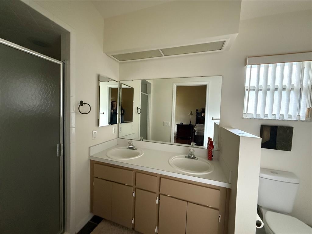 5510 Shriver Street Leesburg, FL 34748 - Photo 9 of 16 a bathroom with a sink a toilet and mirror