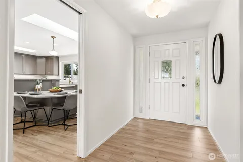 a kitchen with stainless steel appliances granite countertop a sink and a refrigerator