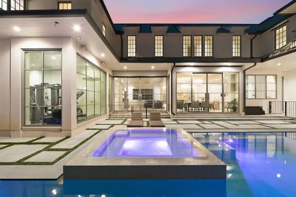 a room with pool table and windows