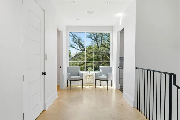 a view of a livingroom with furniture and floor to ceiling window