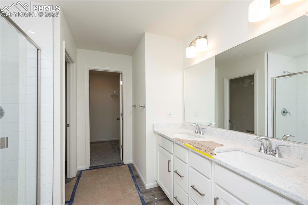 644 Felicity Loop Castle Rock, CO 80109 - Photo 17 of 23 a bathroom with a double vanity sink and a mirror