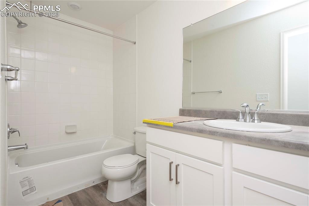 644 Felicity Loop Castle Rock, CO 80109 - Photo 19 of 23 a bathroom with a granite countertop sink toilet and shower
