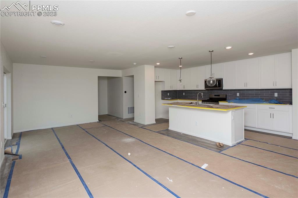 644 Felicity Loop Castle Rock, CO 80109 - Photo 6 of 23 a kitchen with stainless steel appliances granite countertop a stove a sink and a refrigerator