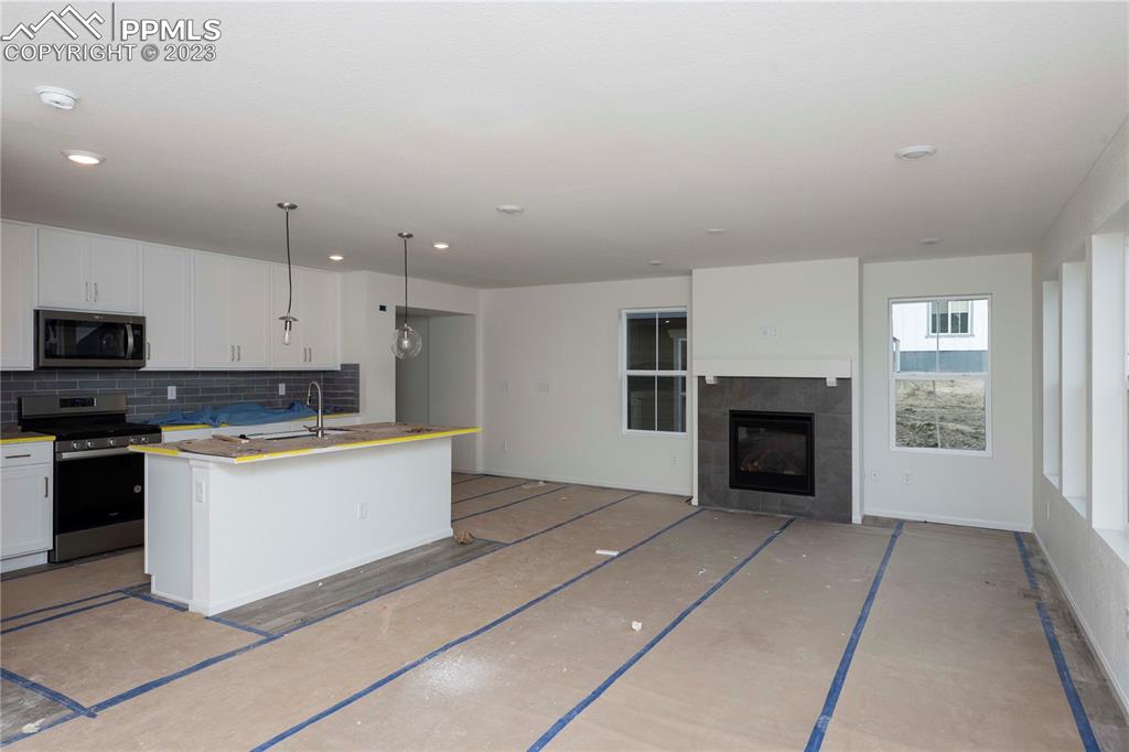 644 Felicity Loop Castle Rock, CO 80109 - Photo 7 of 23 a large kitchen with cabinets appliances and a window