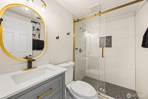 a bathroom with a sink a toilet and shower