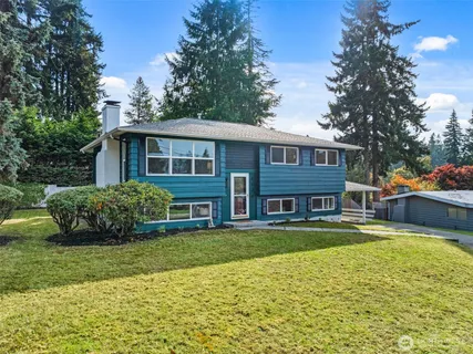 a view of a house with swimming pool and a yard