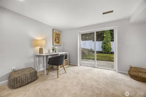 a living room with furniture and a floor to ceiling window
