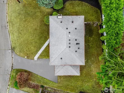 an aerial view of a house with a yard