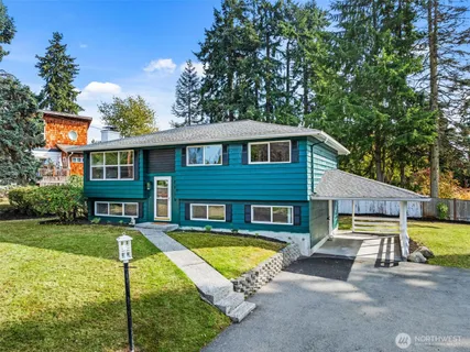 a view of a house with swimming pool and a yard