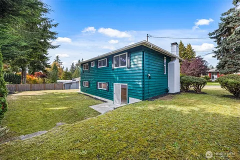 a view of a backyard with large trees