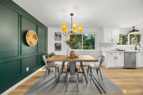 a dining room with a wooden table and chairs
