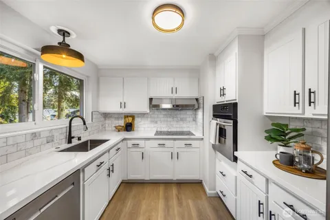 a kitchen with cabinets a sink and a window