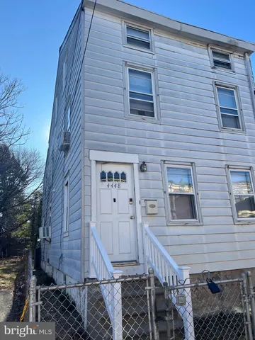 a view of a brick house with wooden door and stairs