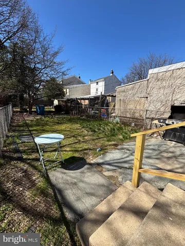 a view of a backyard with swimming pool