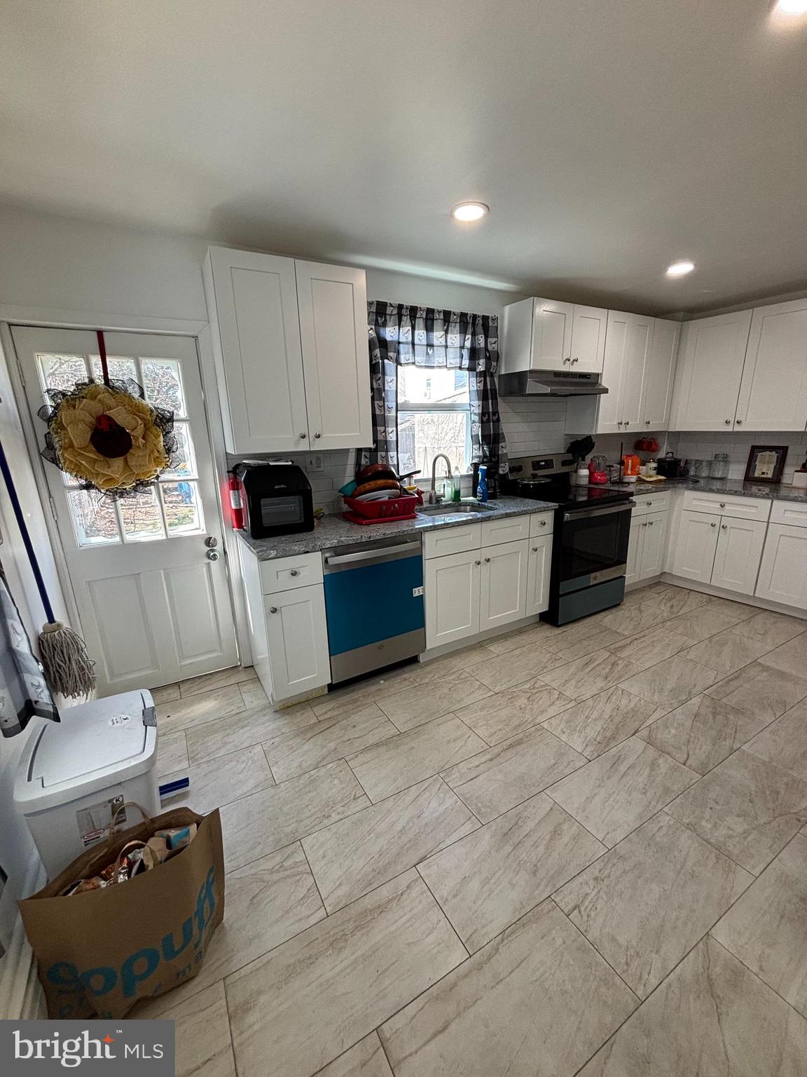 4448 Mitchell Street Philadelphia, PA 19128 - Photo 7 of 22 a kitchen with stainless steel appliances granite countertop a sink and a stove