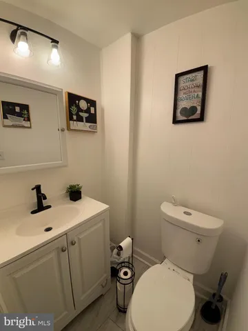 a white toilet sitting next to a bathroom sink