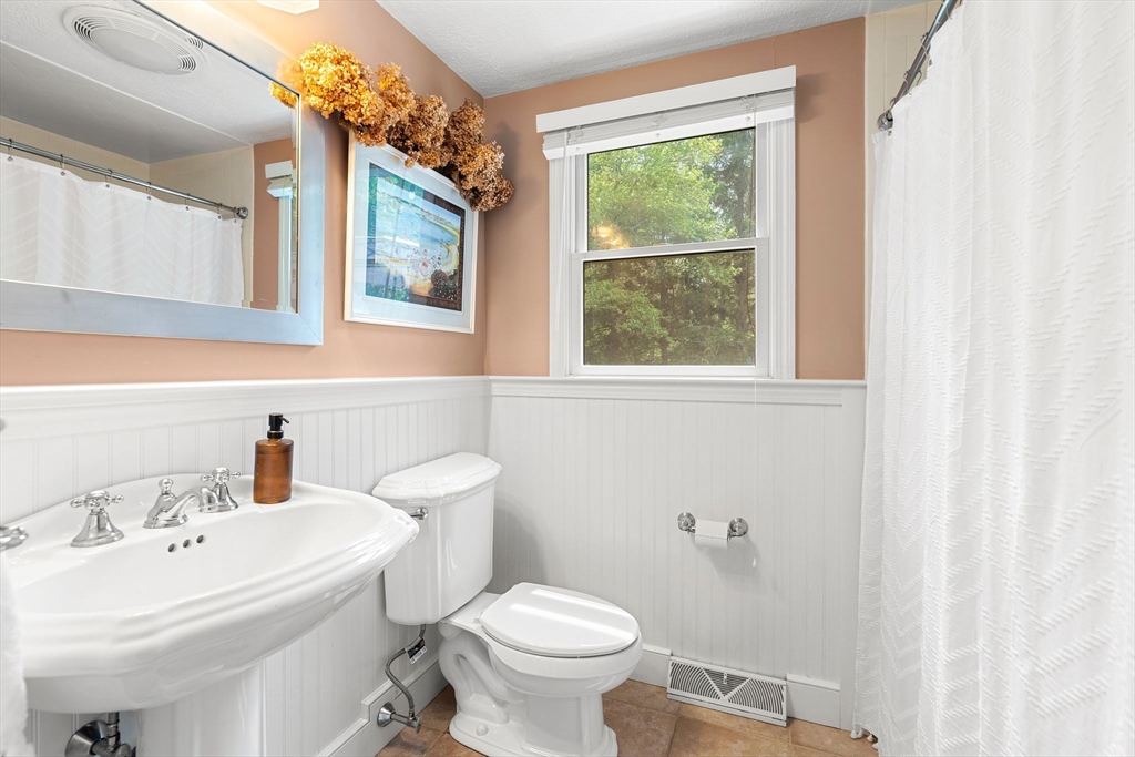 35 Spallus Road Stoughton, MA 02072 - Photo 29 of 39 a bathroom with a sink a toilet and a mirror