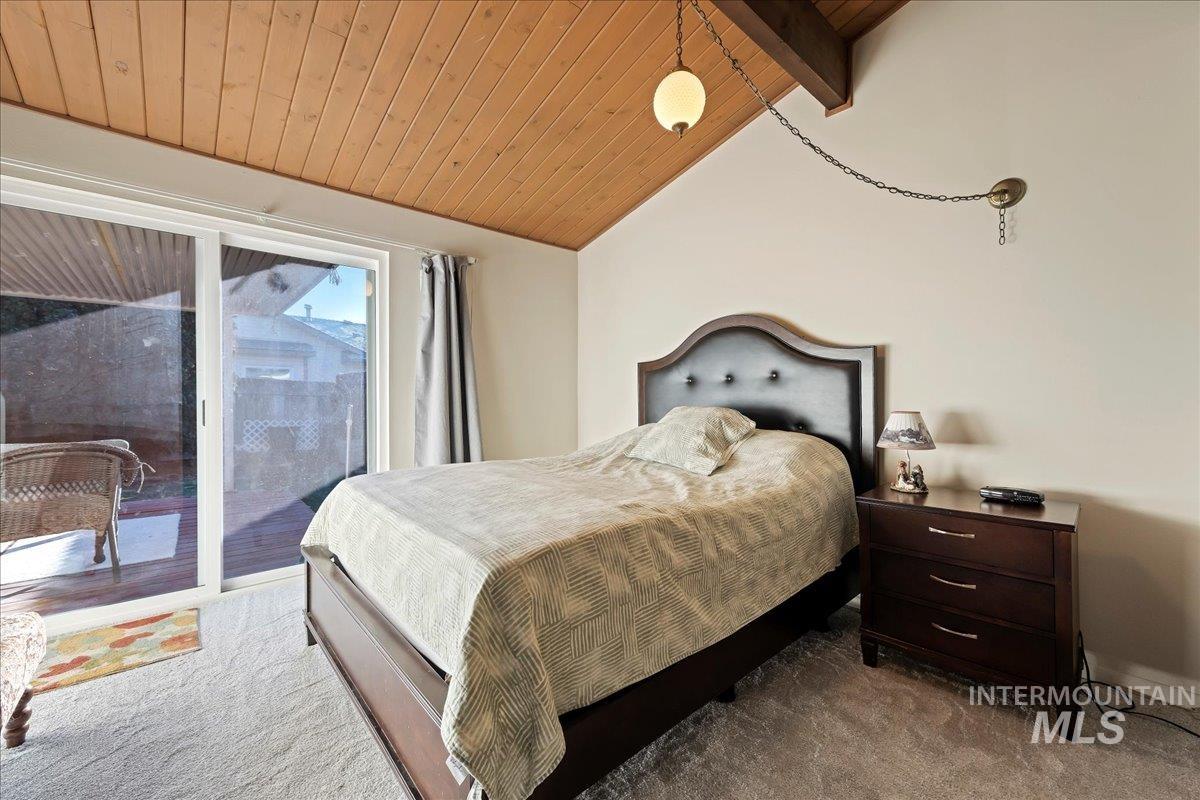 4747 Albion Street, Unit J Boise, ID 83705 - Photo 12 of 21 Carpeted bedroom with wood ceiling and access to exterior