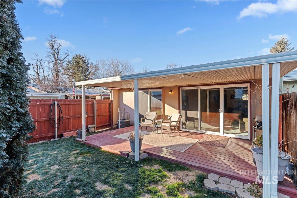 4747 Albion Street, Unit J Boise, ID 83705 - Photo 21 of 21 Rear view of property featuring a fenced backyard and a deck