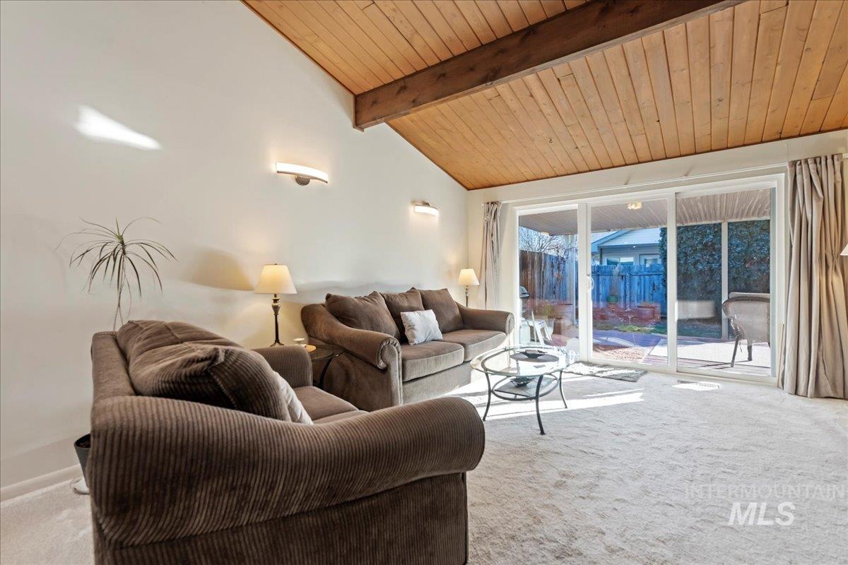 4747 Albion Street, Unit J Boise, ID 83705 - Photo 6 of 21 Living area featuring light colored carpet and wood ceiling